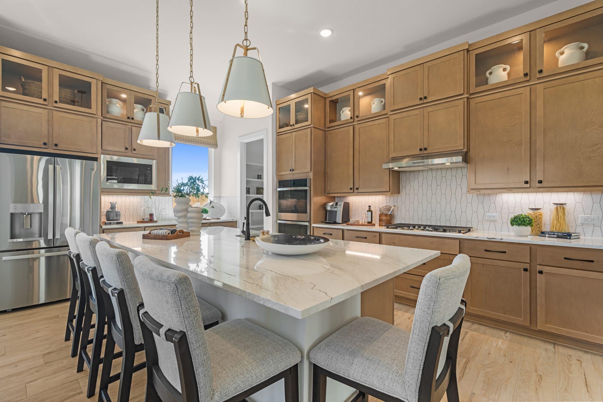 205 Purple Muhly Road Georgetown, TX 78633 - Photo 12 of 23 a kitchen with stainless steel appliances granite countertop a dining table chairs sink and cabinets