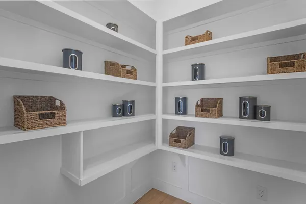 a view of kitchen with cabinets and refrigerator