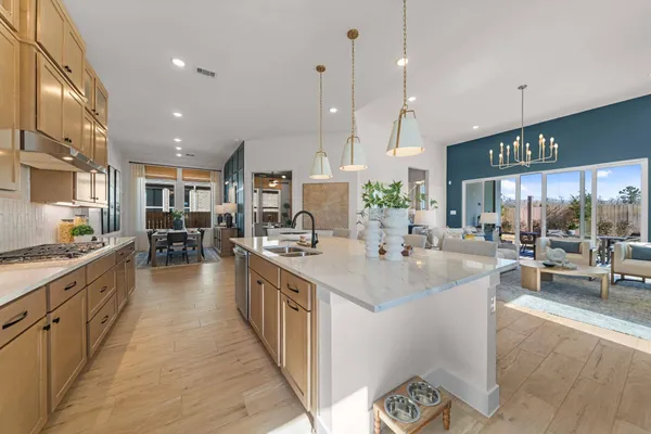 a large kitchen with kitchen island a large island in it