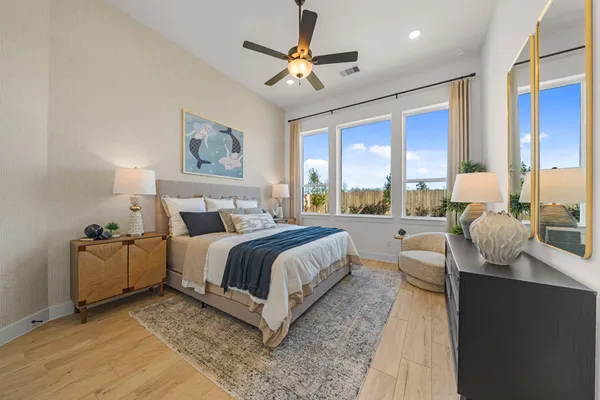 a spacious bedroom with a bed and glass windows
