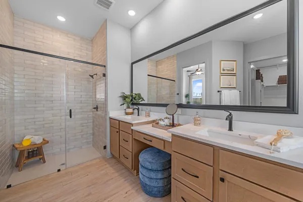 a bathroom with a double vanity sink mirror and