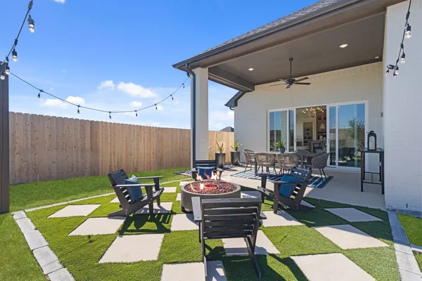a patio with a table and chairs