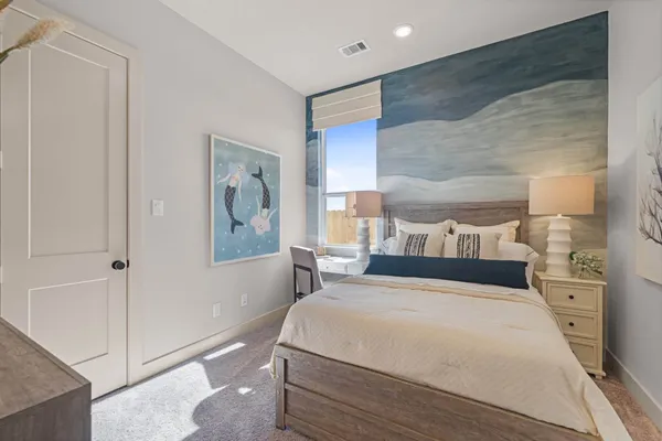 a bedroom with a large bed and a painting on the wall