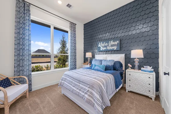 a bedroom with a bed couch and window