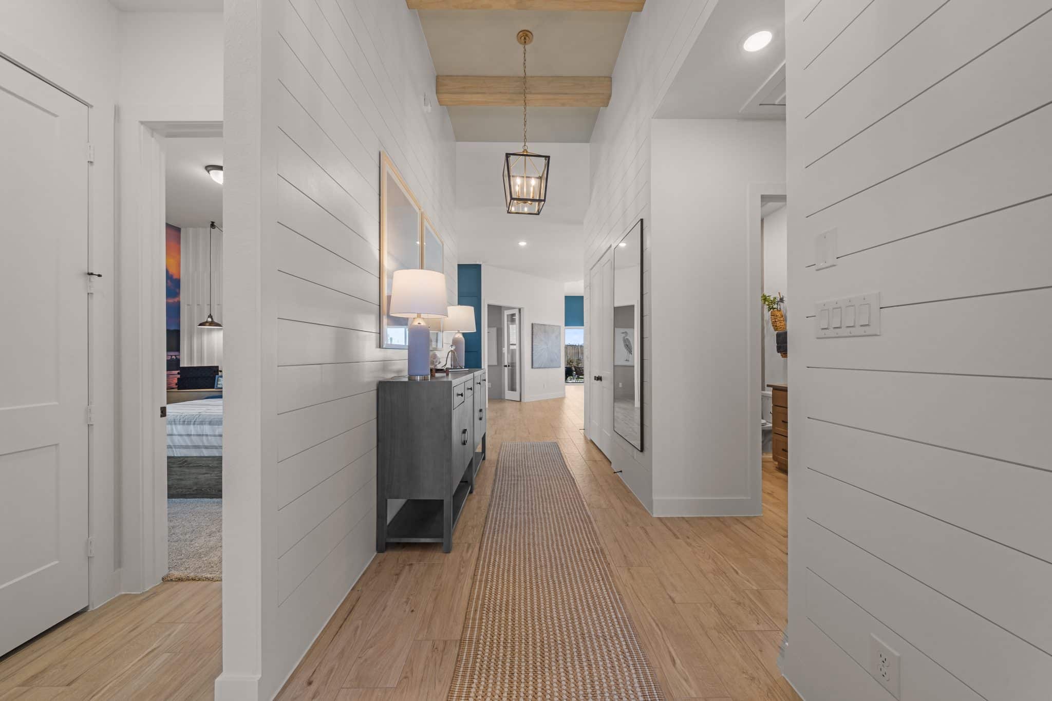 205 Purple Muhly Road Georgetown, TX 78633 - Photo 8 of 23 a view of a hallway with wooden floor and staircase