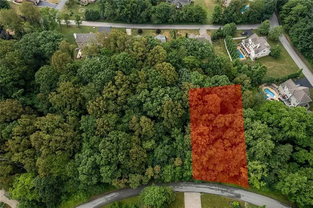 an aerial view of residential house with outdoor space and trees around