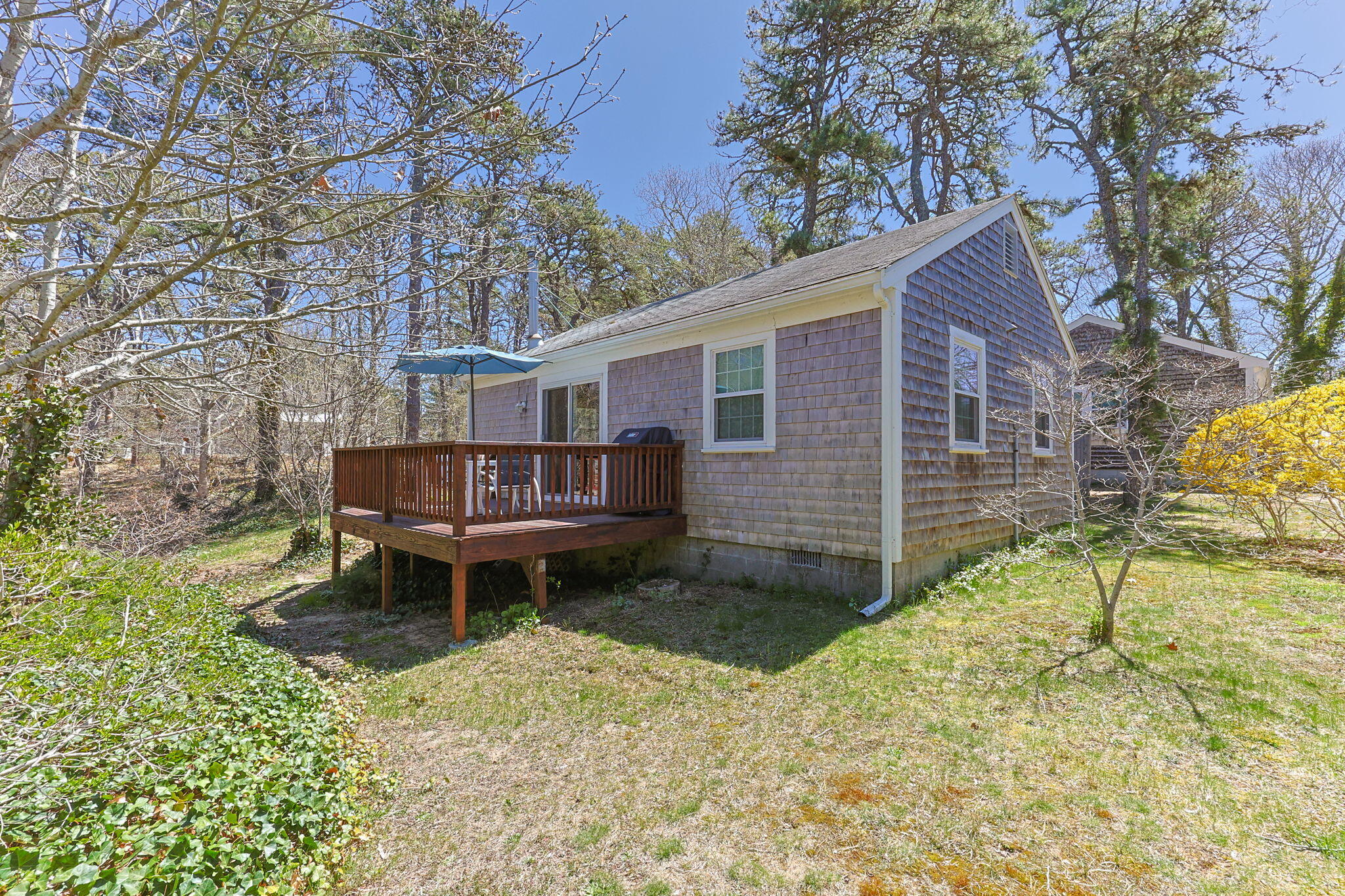 60 Long Avenue, Unit A Wellfleet, MA 02667 - Photo 27 of 28 a backyard of a house with barbeque oven table and chairs