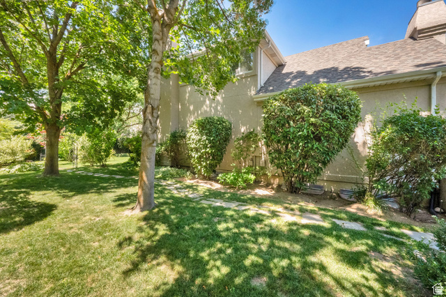 7740 Keswick Road Sandy, UT 84093 - Photo 58 of 74 Expansive green lawn with mature trees and stepping stone path