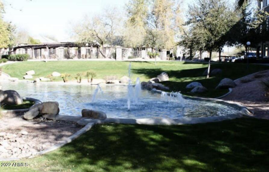 a view of a lake with a yard and outdoor seating