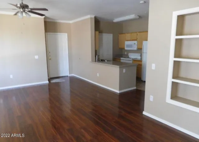 a view of a kitchen from the hallway with a sink