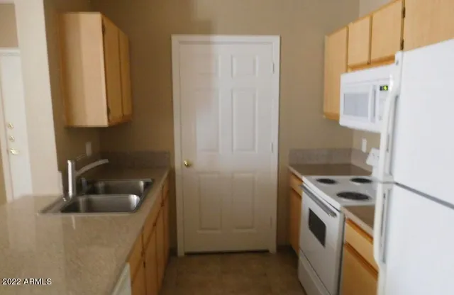 a kitchen that has a sink and a stove