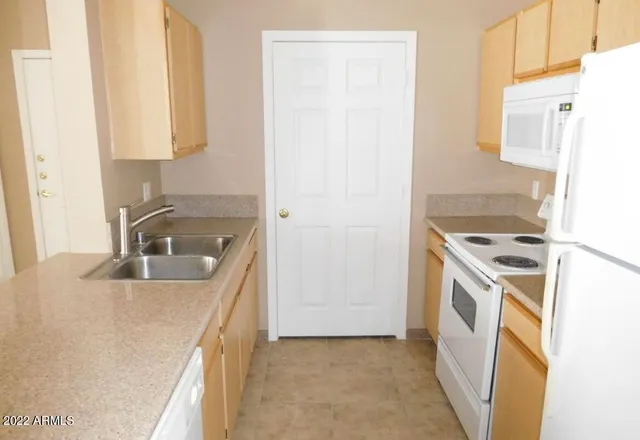 a kitchen with a sink stove and refrigerator