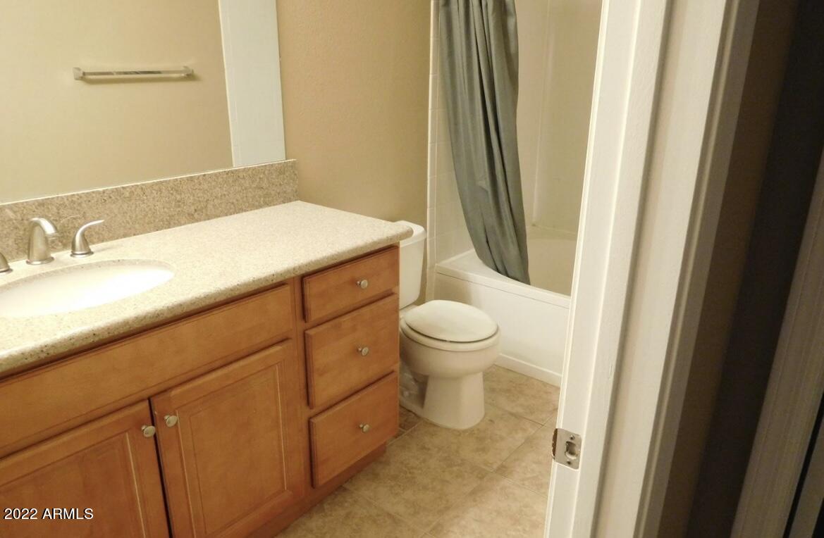 5345 East Van Buren Street, Unit 238 Phoenix, AZ 85008 - Photo 17 of 25 a bathroom with a sink and a mirror