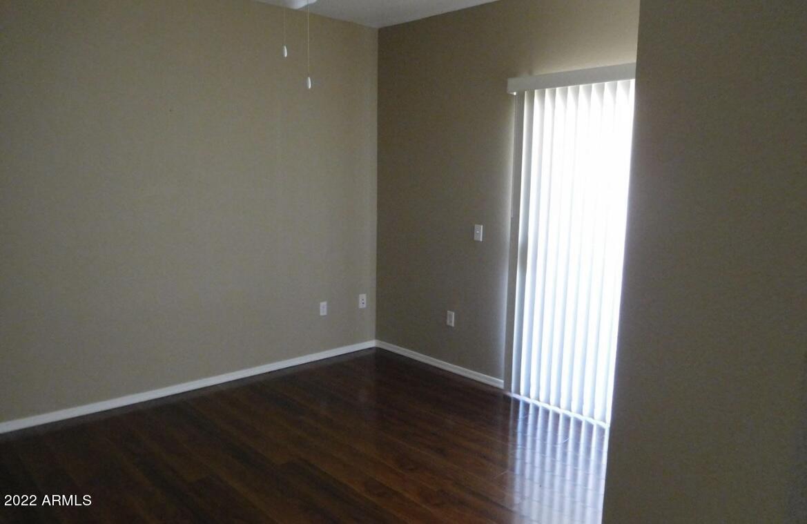 5345 East Van Buren Street, Unit 238 Phoenix, AZ 85008 - Photo 19 of 25 an empty room and wooden floor
