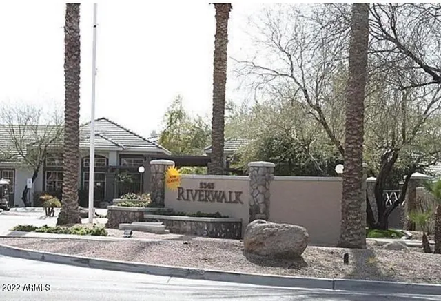 a view of a house with a yard and pathway
