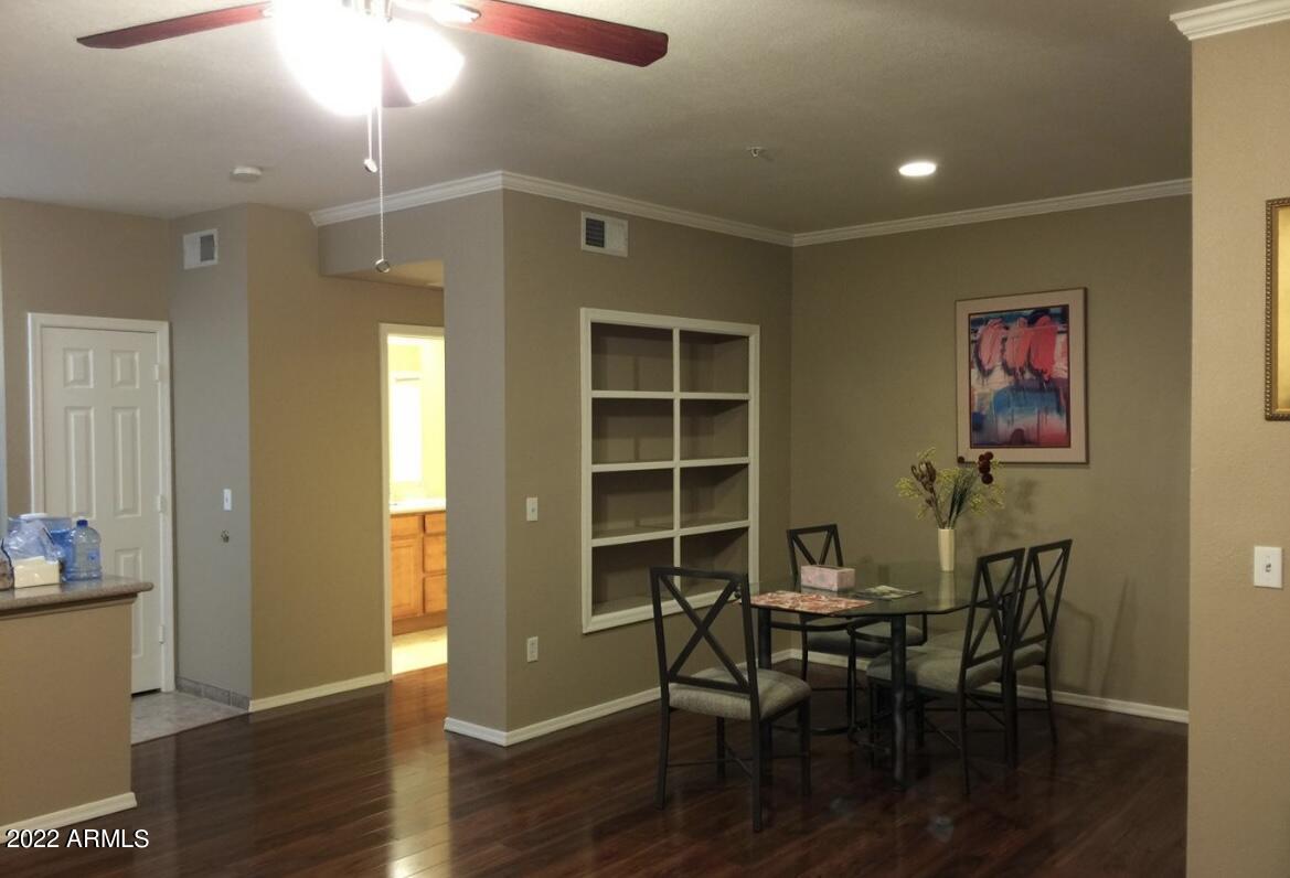 5345 East Van Buren Street, Unit 238 Phoenix, AZ 85008 - Photo 25 of 25 a view of a dining room with furniture and wooden floor