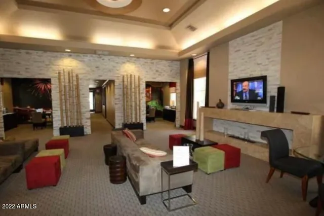 a living room with furniture kitchen view and a fireplace