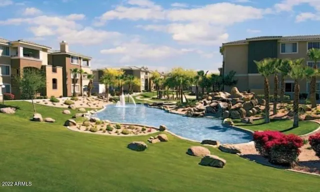 a view of a backyard with table and chairs potted plants and palm trees