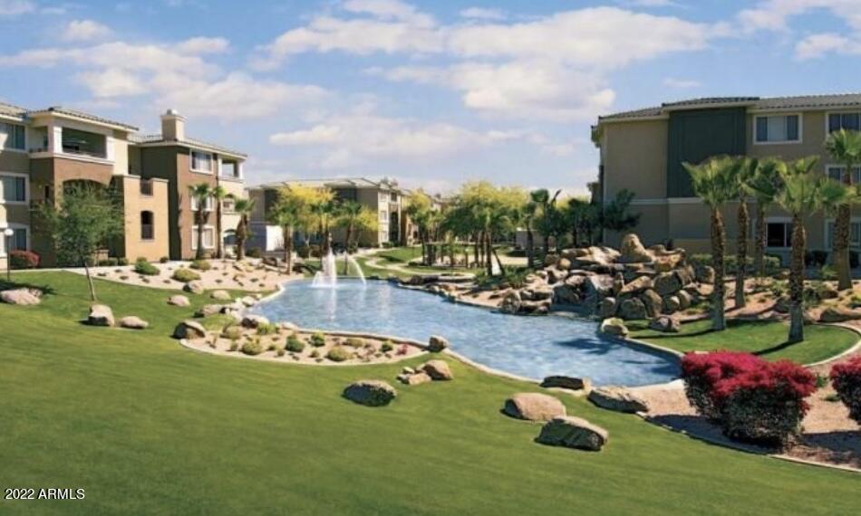 5345 East Van Buren Street, Unit 238 Phoenix, AZ 85008 - Photo 8 of 25 a view of a backyard with table and chairs potted plants and palm trees