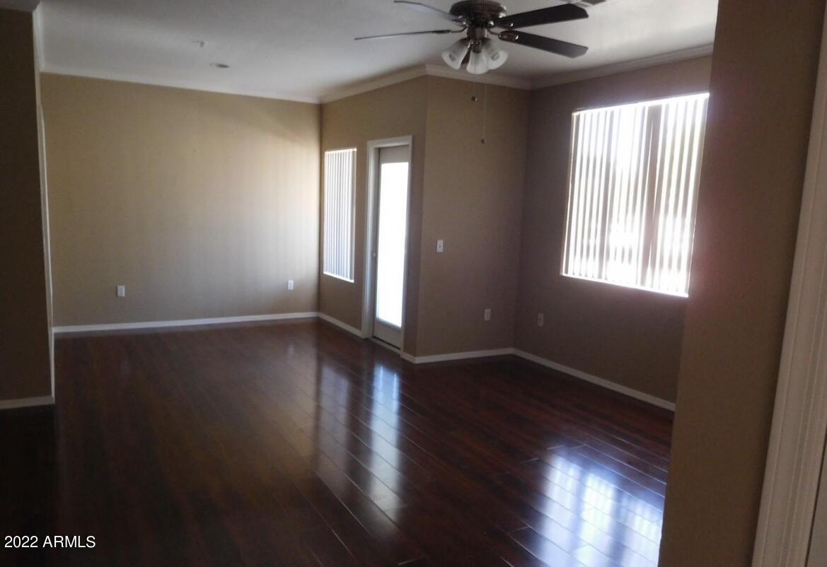5345 East Van Buren Street, Unit 238 Phoenix, AZ 85008 - Photo 10 of 25 a view of an empty room with wooden floor and a window