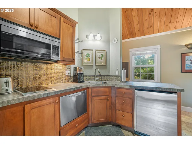 a kitchen with stainless steel appliances a sink stove and microwave