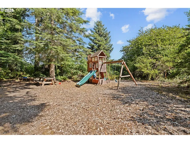 a view of outdoor space with playground and green space