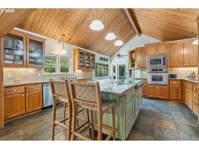 a kitchen with stainless steel appliances granite countertop a sink and cabinets