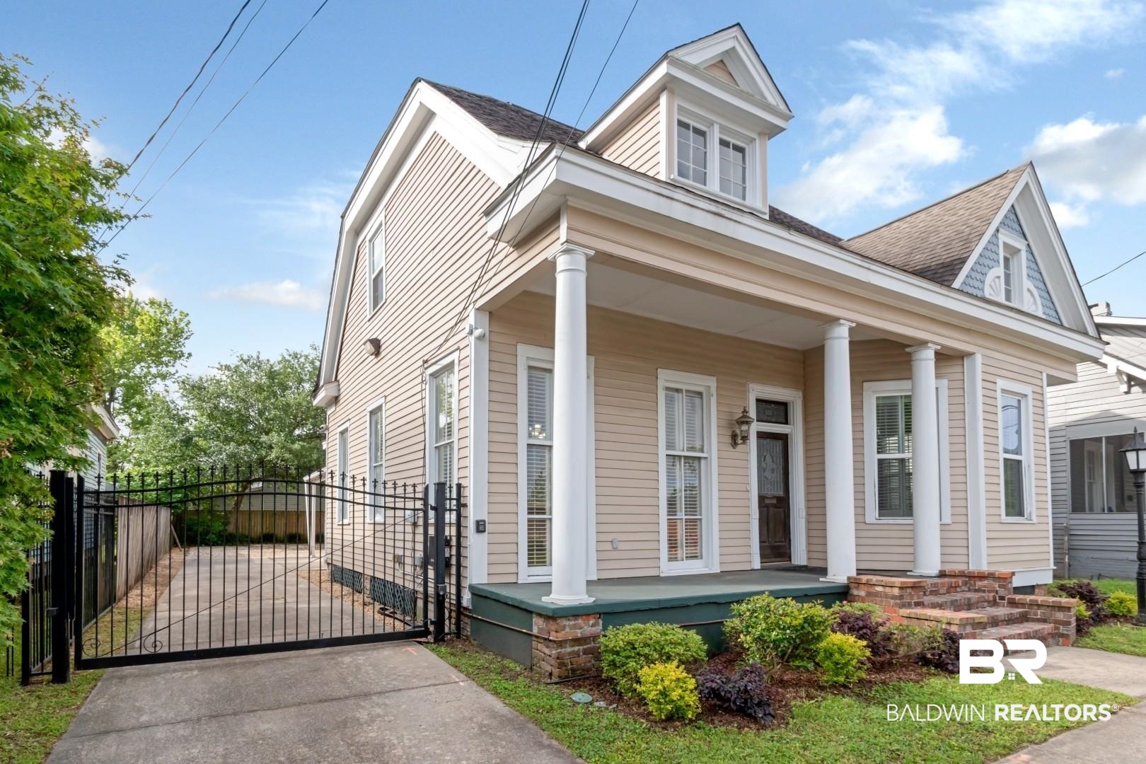 605 St Francis Street Mobile, AL 36602 - Photo 35 of 40 View of front of house featuring a porch, a gate, fence, and a shingled roof