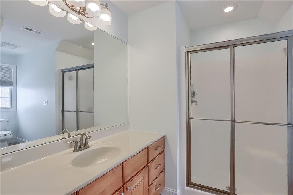 820 Mt Pleasant Road Mars, PA 16046 - Photo 14 of 25 A private bath features a tub/shower combo, large vanity tile flooring and modern lighting.