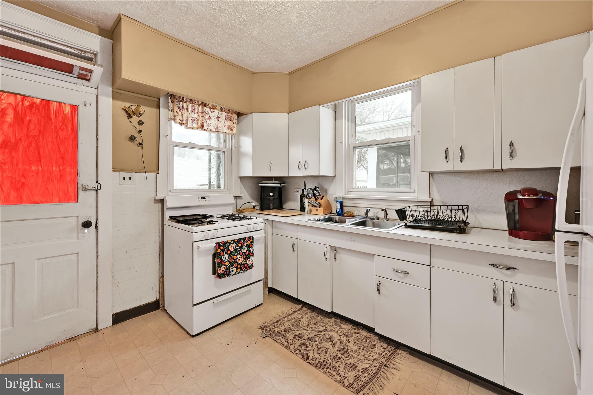 544 Spruce Street Steelton, PA 17113 - Photo 16 of 33 a kitchen with white cabinets and white appliances