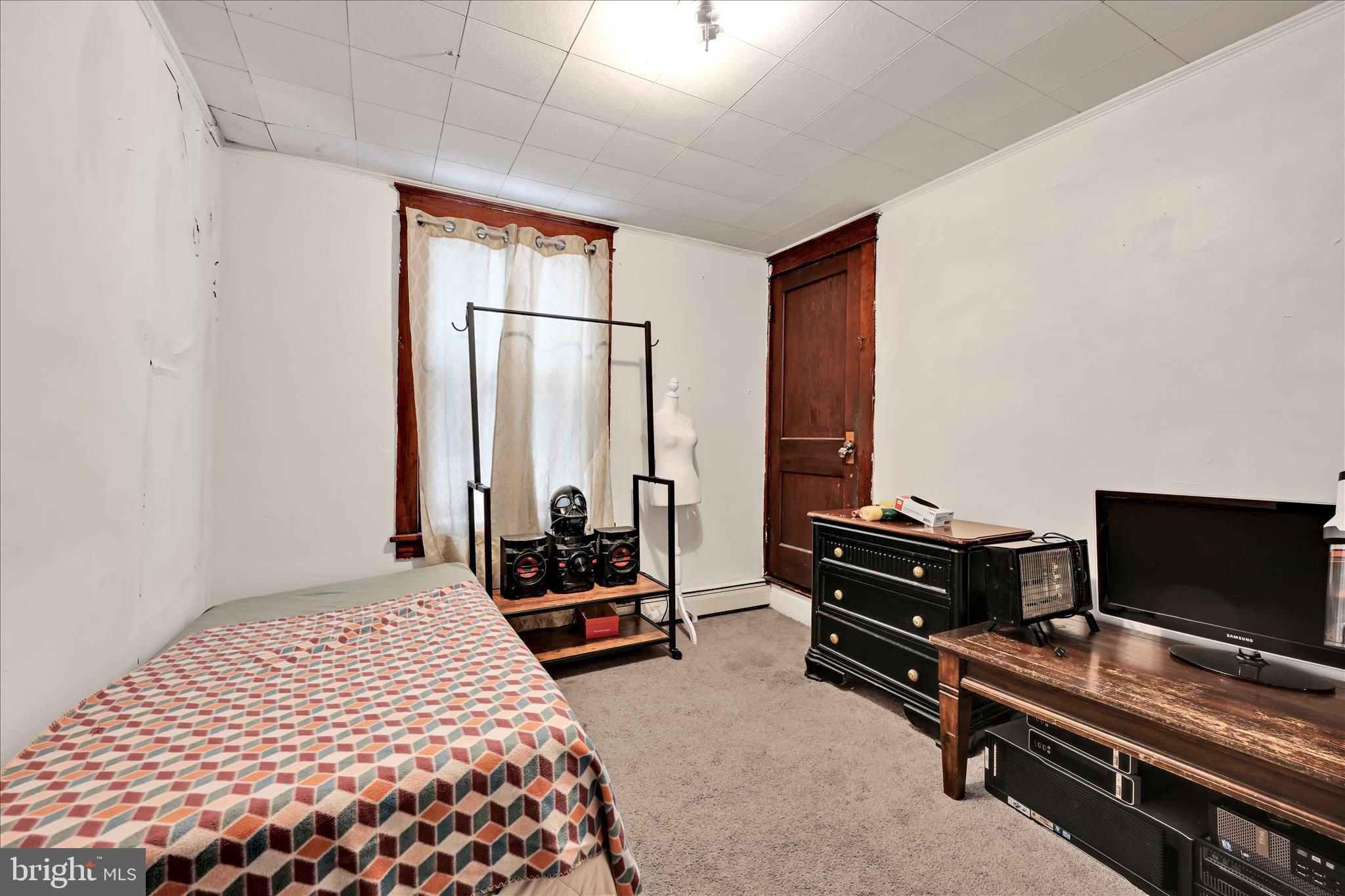 544 Spruce Street Steelton, PA 17113 - Photo 22 of 33 a bedroom with a bed and a flat screen tv
