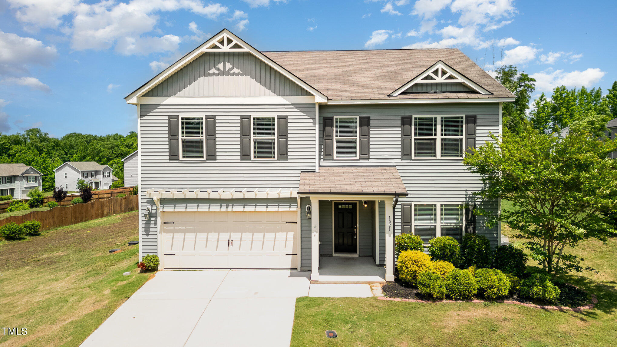 1021 Silver Farm Road Raleigh, NC 27603 - Photo 2 of 42 a front view of a house with a yard and garage