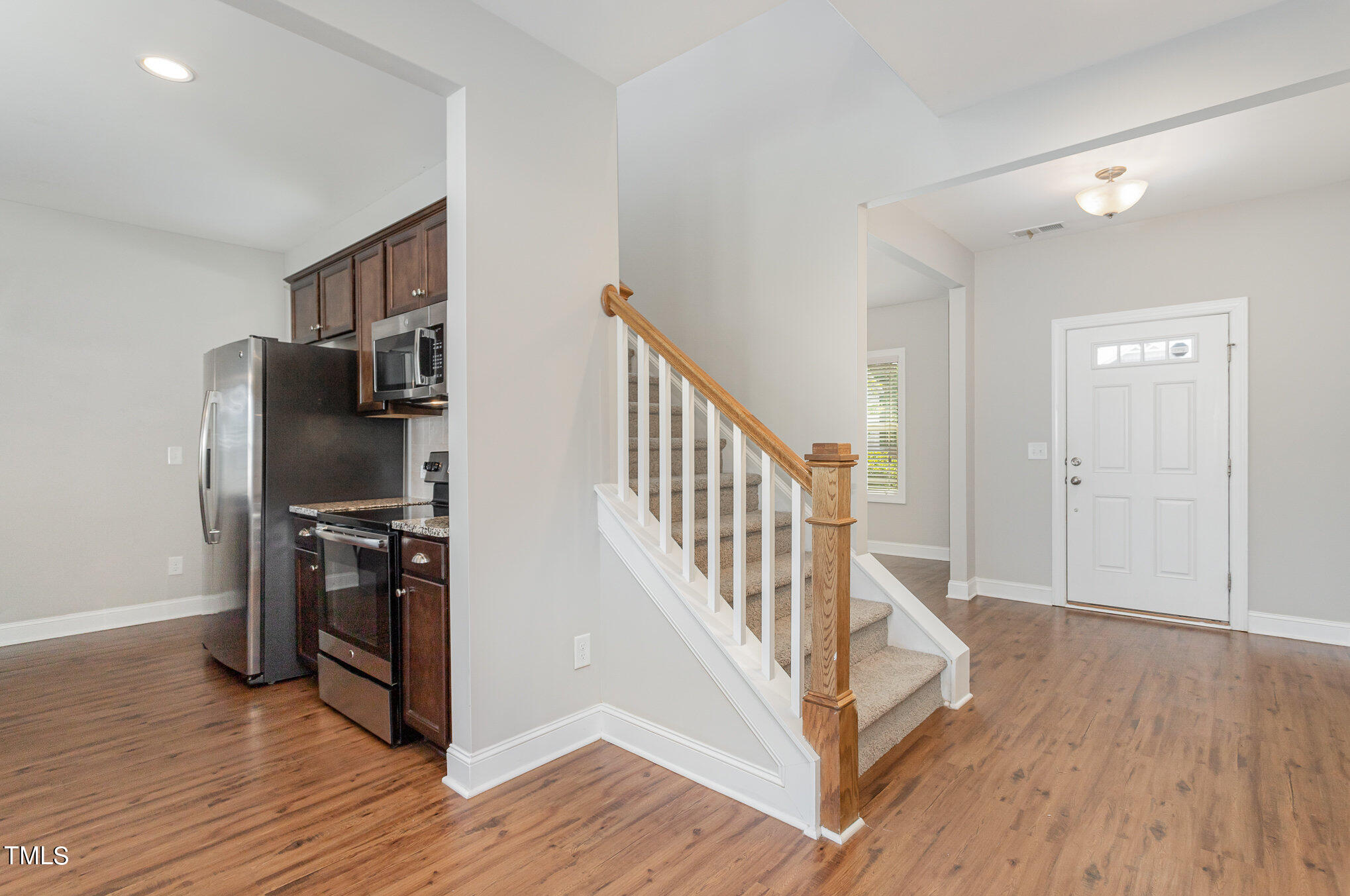 1021 Silver Farm Road Raleigh, NC 27603 - Photo 6 of 42 a view of a livingroom with wooden floor and stairs