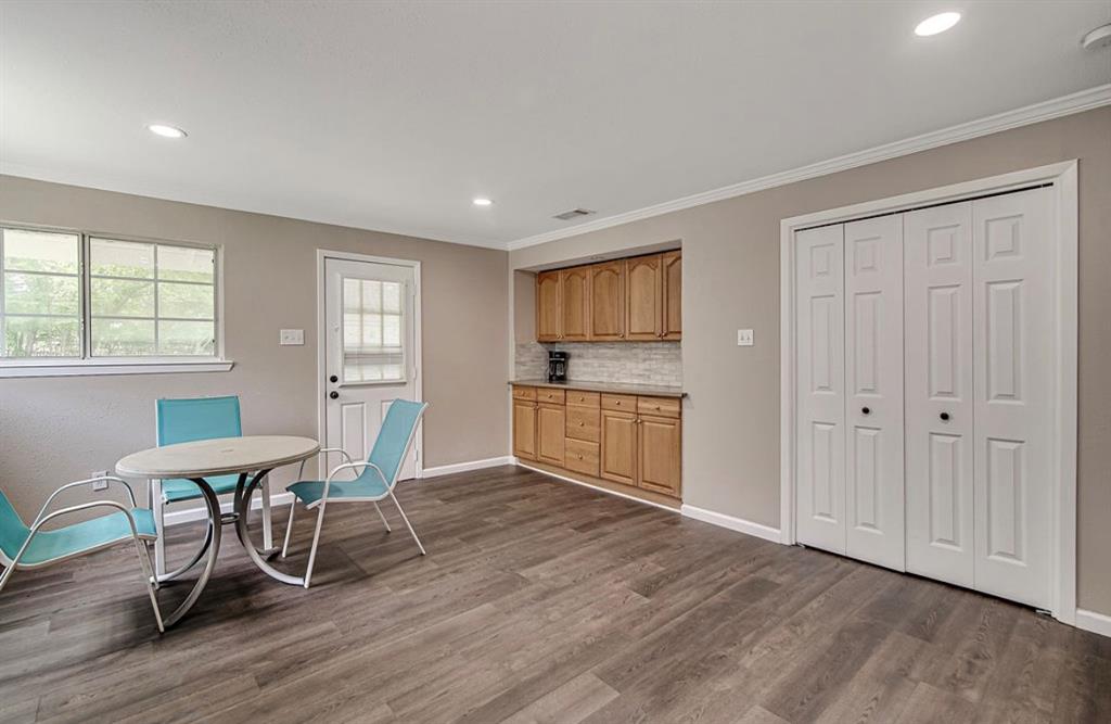 3952 J J Rendon Road Burleson, TX 76028 - Photo 9 of 25 Built in buffet, and the double doors open to your full size laundry area complete with a washer and dryer to convey with the property.