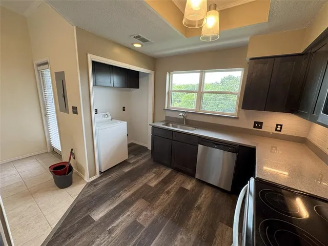 a kitchen with a sink and a stove top oven