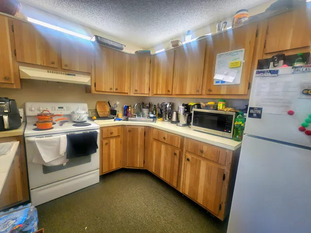 a kitchen with a sink stove and cabinets