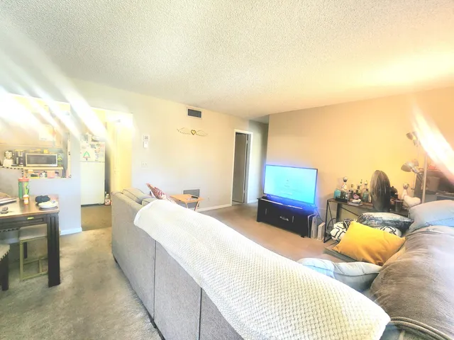 a spacious bedroom with a bed and a couch