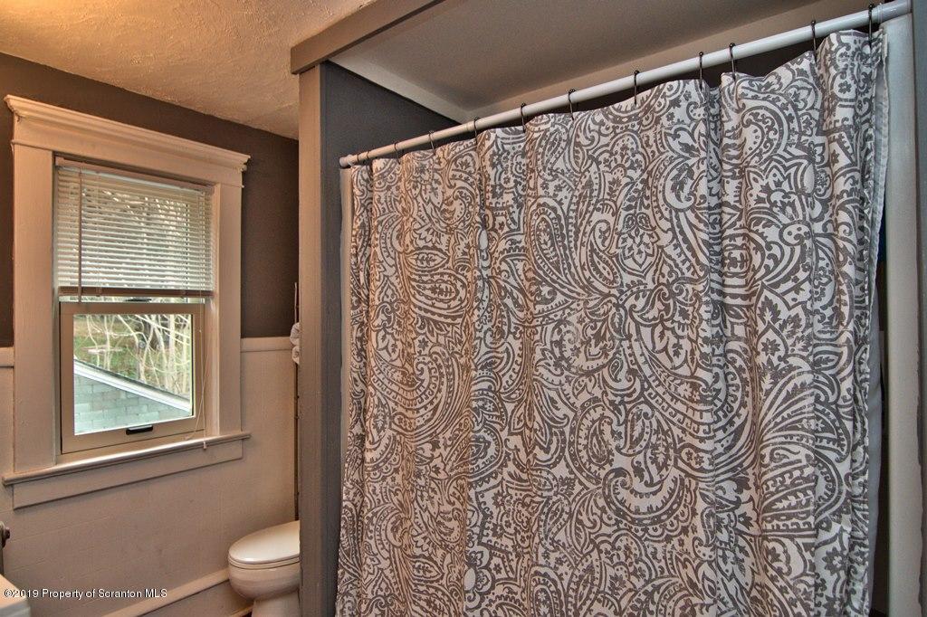 1428 Hillside Road Shavertown, PA 18708 - Photo 15 of 19 a bathroom with a toilet and a shower curtain