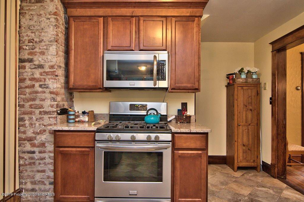1428 Hillside Road Shavertown, PA 18708 - Photo 10 of 19 a kitchen with stainless steel appliances wooden cabinets and a stove top oven