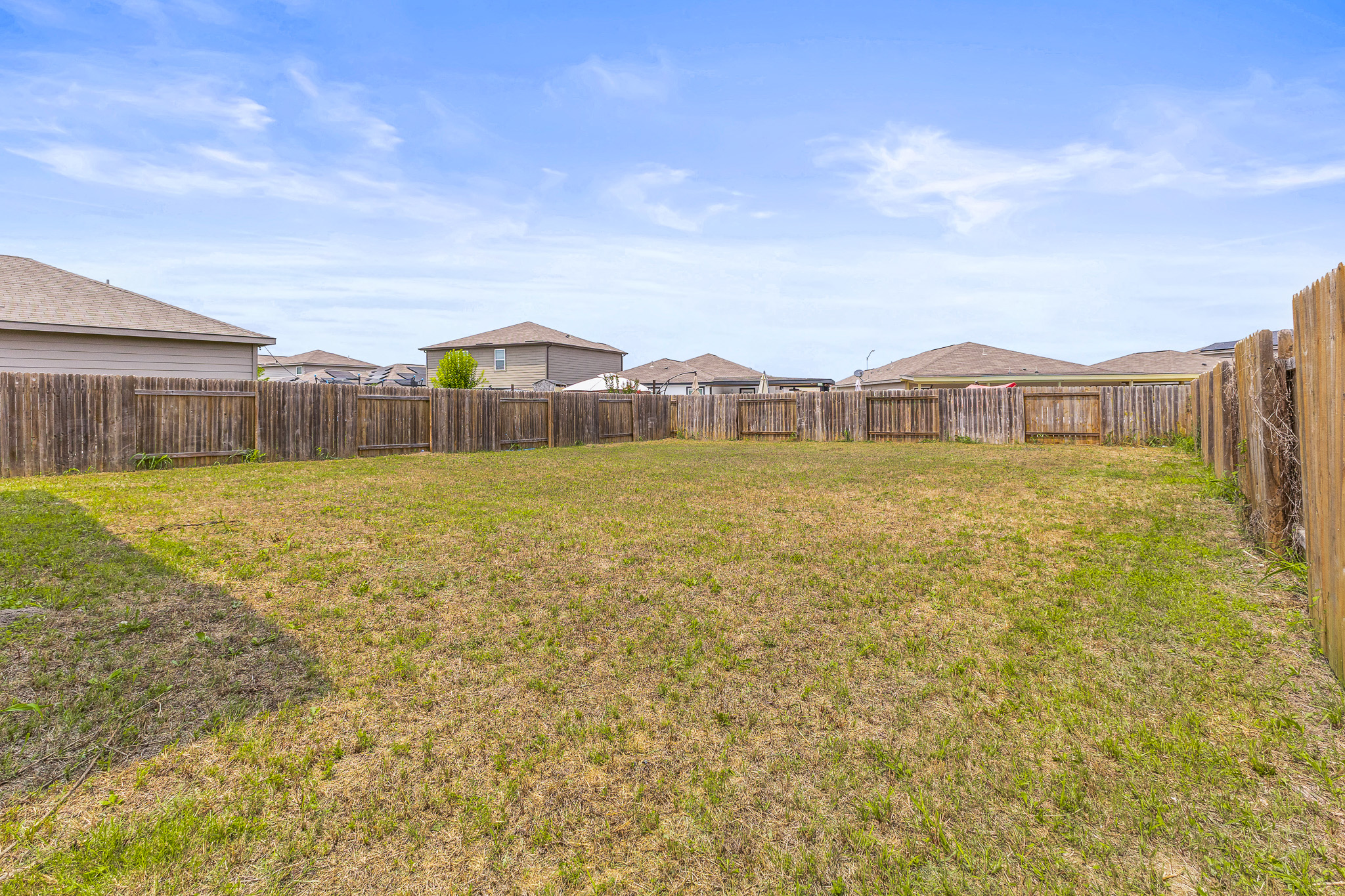 304 Hyacinth Way, Unit #7K Jarrell, TX 76537 - Photo 26 of 26 Secure yard featuring robust wood fencing provides ample space for outdoor activities.