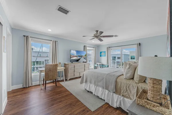 a bedroom with a bed and a large window
