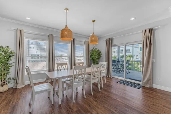 a view of a dining room with furniture and a chandelier