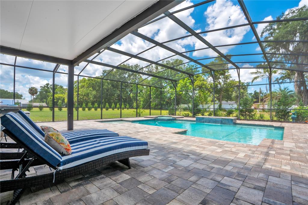 5785 Gilliam Road Orlando, FL 32818 - Photo 52 of 100 a view of a patio with a table chairs and a small yard