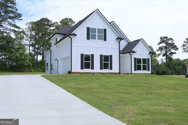 a front view of a house with a garden