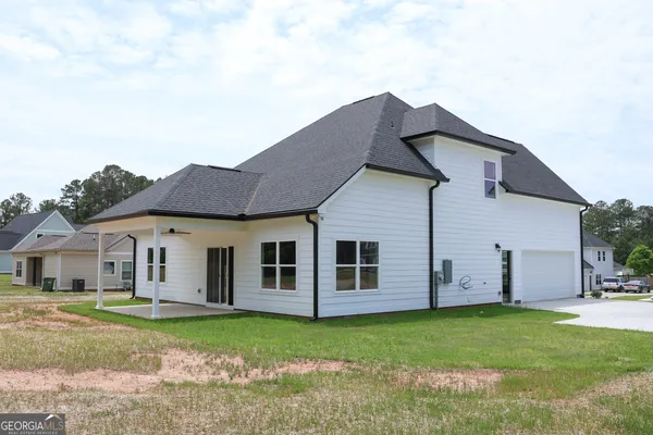 a house that has a big yard with large trees