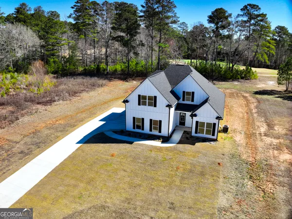 an aerial view of residential houses with outdoor space