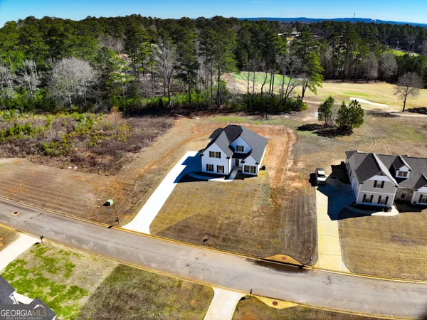 an aerial view of a house with a swimming pool