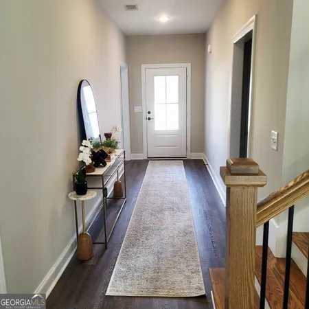 a view of a hallway with workspace and a window