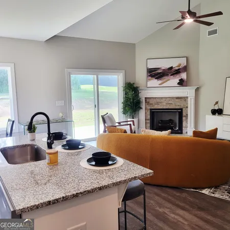 a living room with granite countertop furniture and fireplace