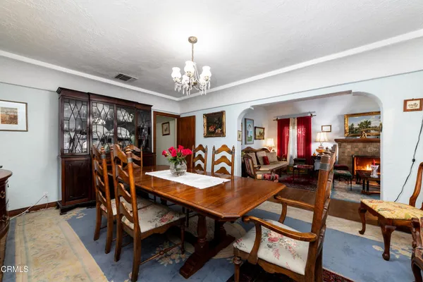 a view of a dining room with furniture wooden floor and a chandelier